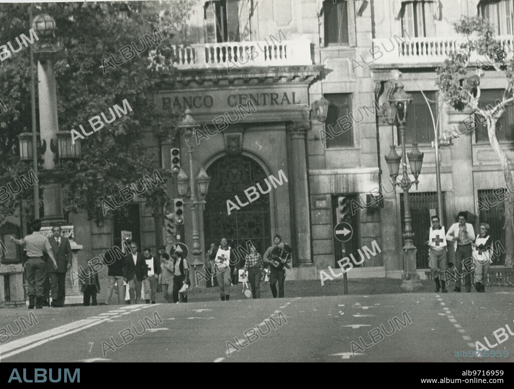 Barcelona 23/05/1981. Atraco al Banco Central de Barcelona. Los atracadores entraron el 23 de mayo a la sede, un edificio de siete plantas en la Plaza de Cataluña. Los GEO actuaron el domingo 24, deteniendo a nueve de los once asaltantes. Uno más fue abatido. En la imagen, miembros de la Cruz Roja salen tras entregar alimentos a los rehenes.