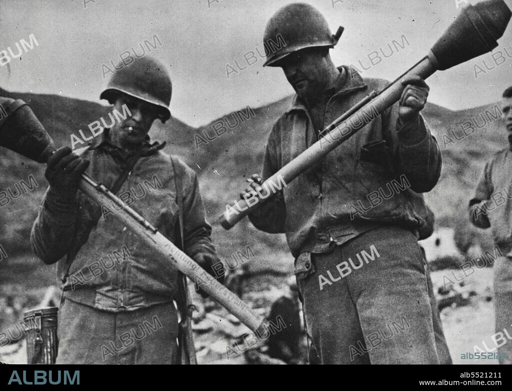 U.S. Soldiers Examine German Bazooka -- German, Bazooka, imitations of the American anti-tank guns, are examined by two U.S. soldiers after the weapons were captured during fighting on the outskirts of Cassino in Western Italy. The bazooka was developed in the United States as an infantryman's anti-tank weapon. March 20, 1944.