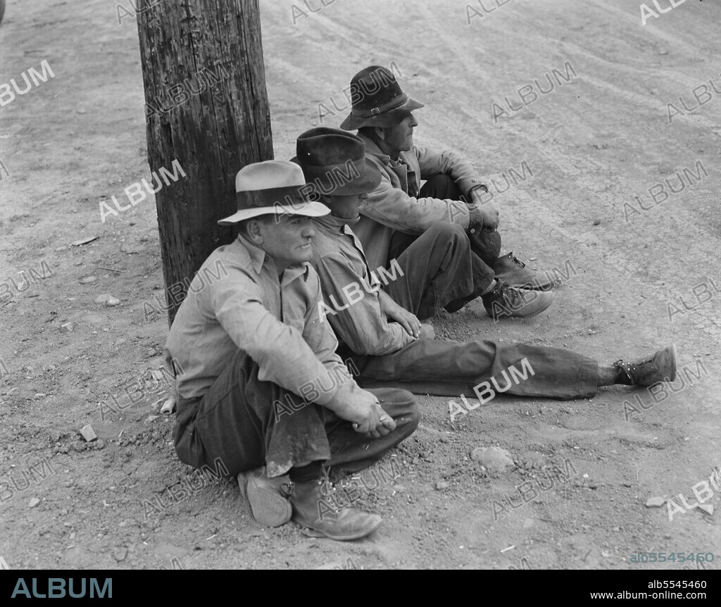 DOROTHEA LANGE. Waiting for the semi-monthly relief checks at Calipatria, California.