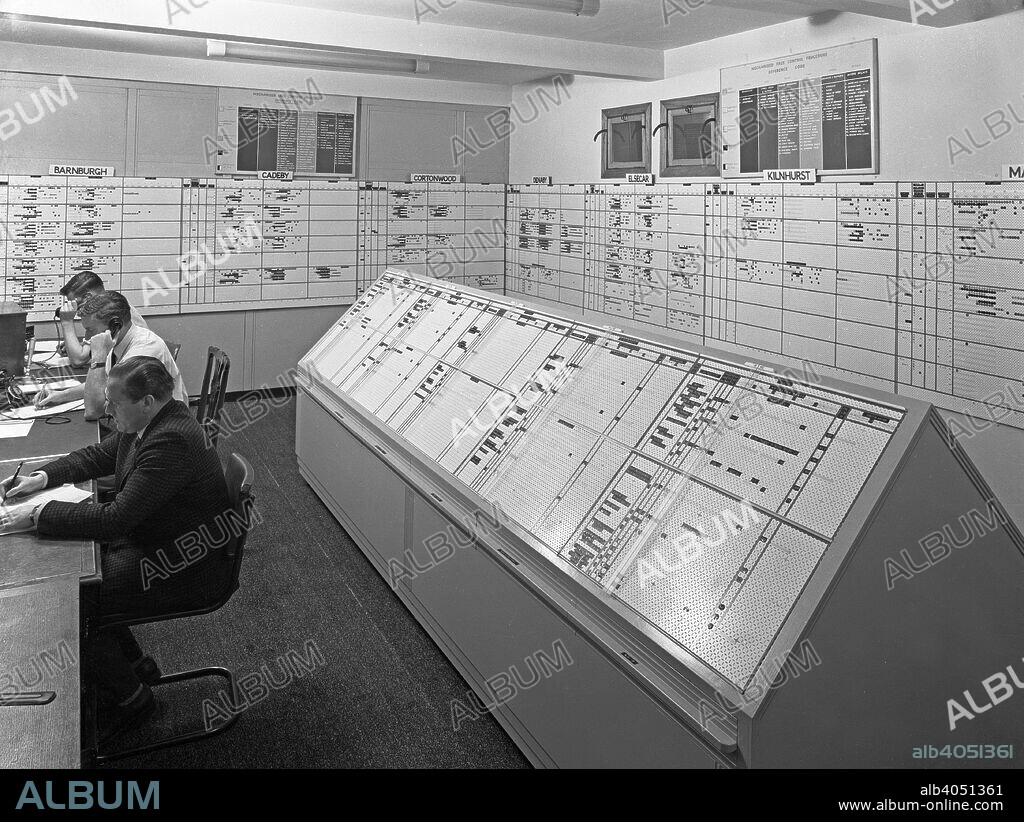 Manvers Main colliery, Wath upon Dearne, near Rotherham, South Yorkshire, October 1965. The Area Face Control Room was situated at the Manvers Main colliery but monitored the performance of all the pits in the area. All the pits that were monitored were listed alphabetically around the room, which was manned 24 hours a day, in case any problems which might arise. The performance of each pit was checked and if problems were detected the men in the room were responsible for calling out the necessary staff to rectify the situation.