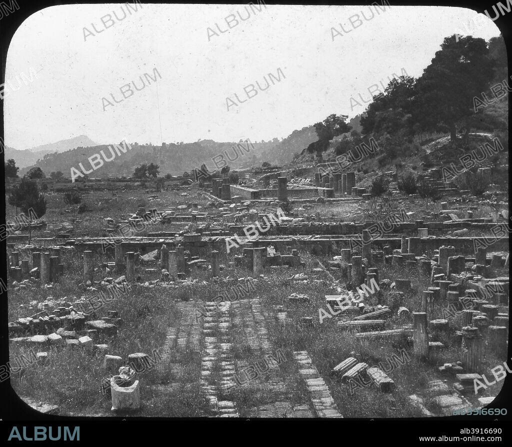 Mount Kronos and Temple of Hera, Olympia, Greece, late 19th or early 20th century. The wife of Zeus, Hera was one of the major goddesses of Ancient Greece. The Romans worshipped her as Juno. The Temple of Hera at Olympia, site of the original Olympic Games, is believed to be the earliest surviving example of Doric architecture. It is thought to date from the early 6th century BC. The temple was destroyed by an earthquake in the 4th century AD. Lantern slide.