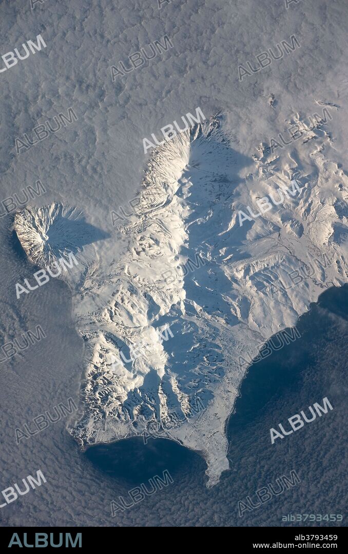 View from space of Southern Paramushir Island, part of the Kuril Island chain, a volcanic island arc that extends from Russia's Kamchatka Peninsula to northern Japan. Four major volcanic centers create this part of the island: Fuss Peak (image center left), the Karpinsky Group (image bottom), the Lomonosov Group (image center), and the Chikurachki cone (image top center).