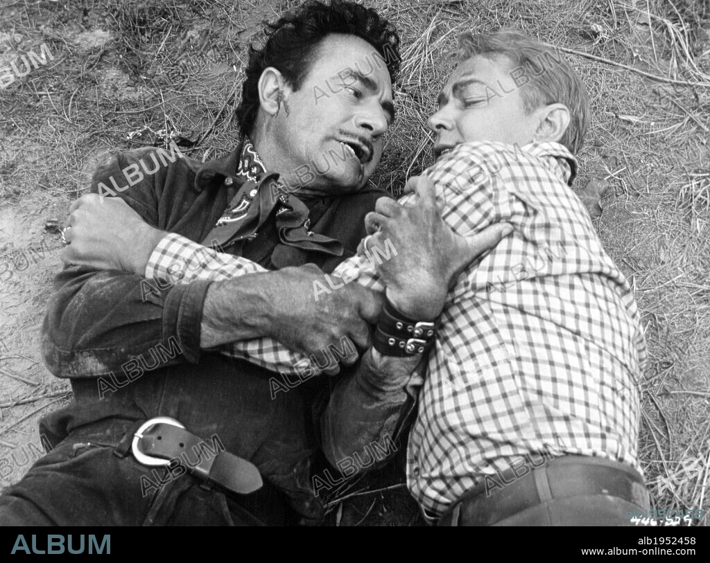 ALAN LADD and GILBERT ROLAND in GUNS OF THE TIMBERLAND, 1960, directed by ROBERT D. WEBB. Copyright WARNER BROS.
