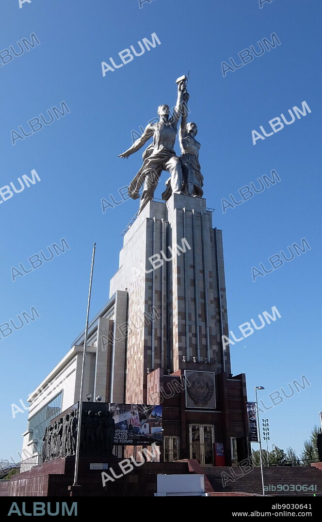 Worker and Kolkhoz Woman sculpture in Moscow, depicts of two figures with a sickle and a hammer raised over their heads. It is 24.5 meters (78 feet) high, made from stainless steel by Vera Mukhina for the 1937 World's Fair in Paris and subsequently moved to Moscow. The sculpture is an example of the socialist realistic style, as well as Art Deco style. The worker holds aloft a hammer and the kolkhoz woman a sickle to form the hammer and sickle symbol.