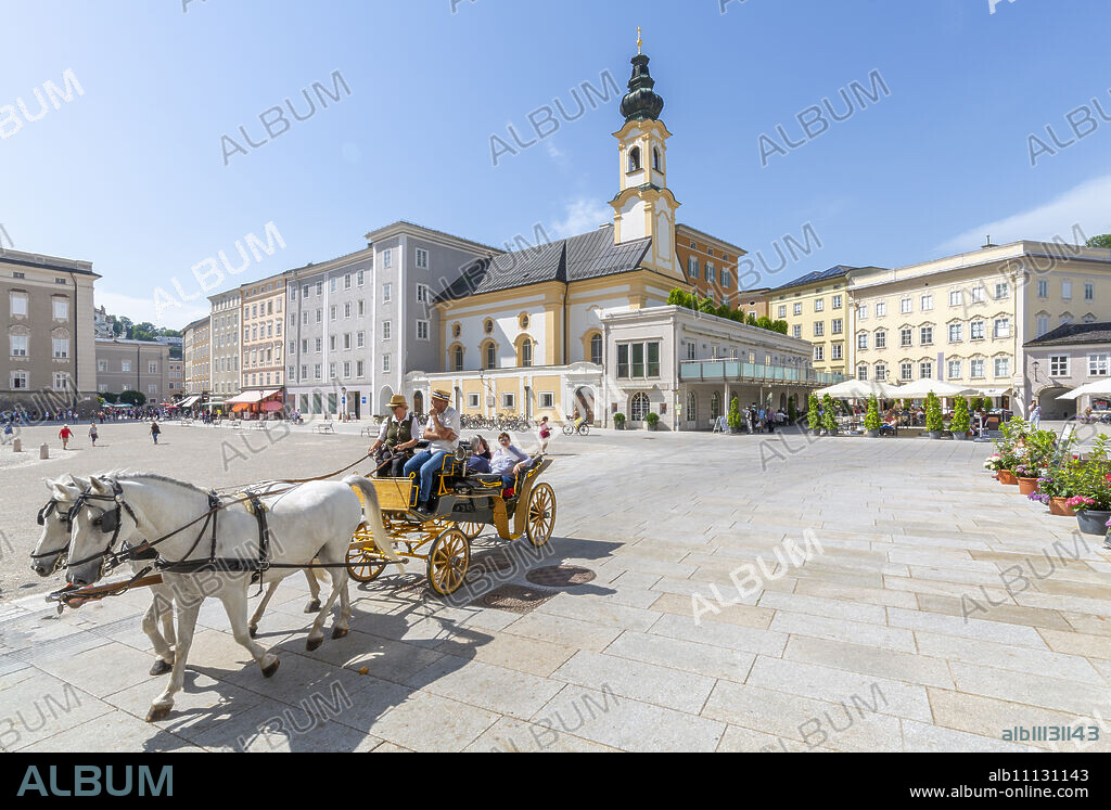 View of St. Michaelskirche and restaurants in Residenzplatz, Salzburg, Austria, Europe.