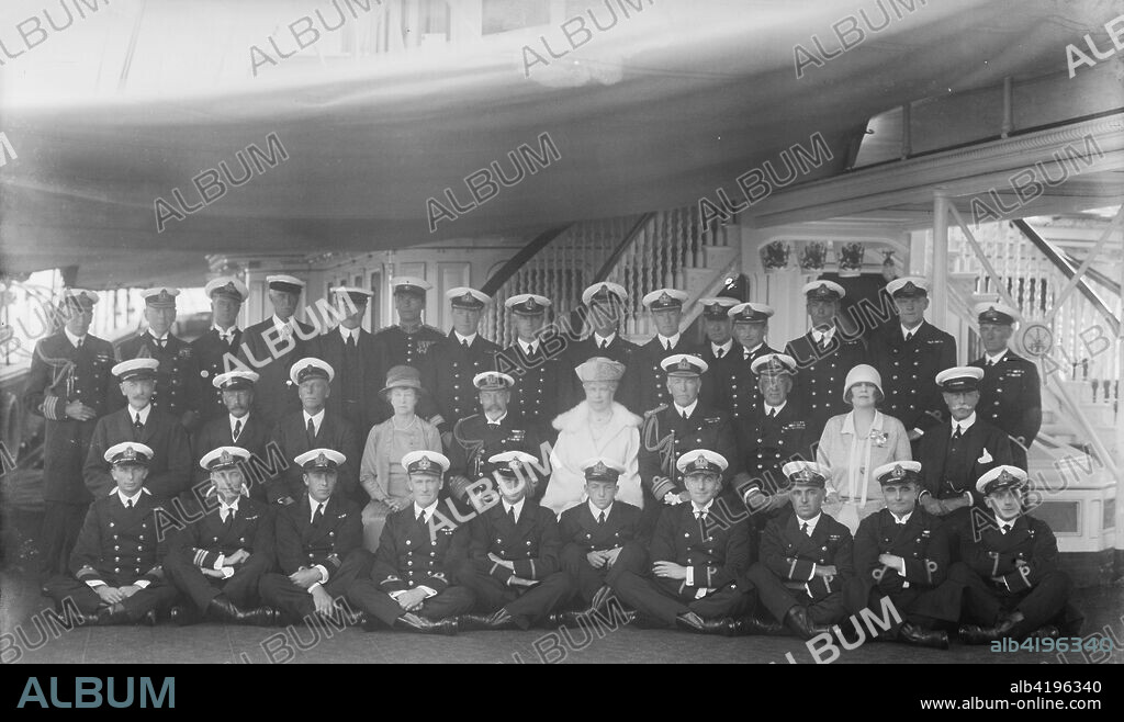 King George V, Queen Mary and crew on board 'HMY Victoria and Albert', 1927. Group portrait of King George V (1865-1936) and Queen Mary (1867-1953) with the crew of the royal yacht 'Victoria and Albert'. Also present are the Marquise d'Hautpoul de Seyre and her brother Sir Harry Stonor, friends and courtiers of the king and queen. 'HMY Victoria and Albert', launched in 1899, was a steamship used by the royal family, particularly for their trips to their summer home, Osborne House, on the Isle of Wight.