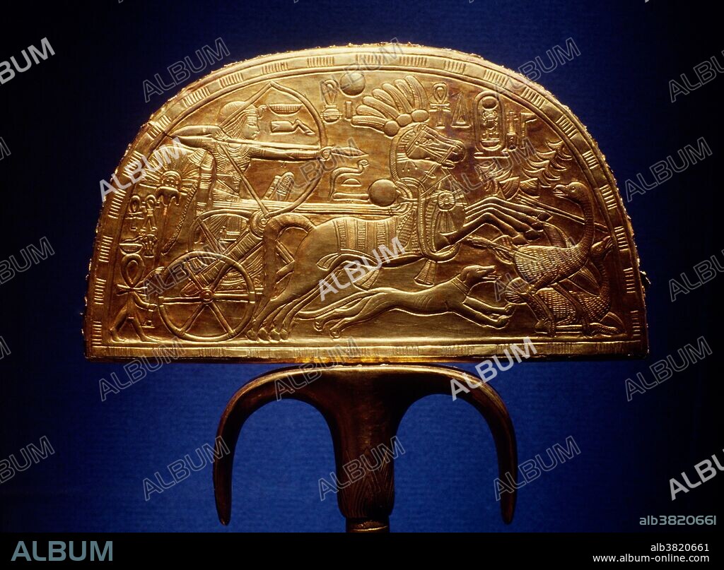 A gilded wooden fan holder depicting Tutankhamun (1341 BCE to 1323 BCE) riding in his chariot while hunting ostriches. This holder was once filled with a fan of ostrich feathers. The reverse side portrays the king's return with the caught ostriches. This piece was found in Tutankhamun's tomb.