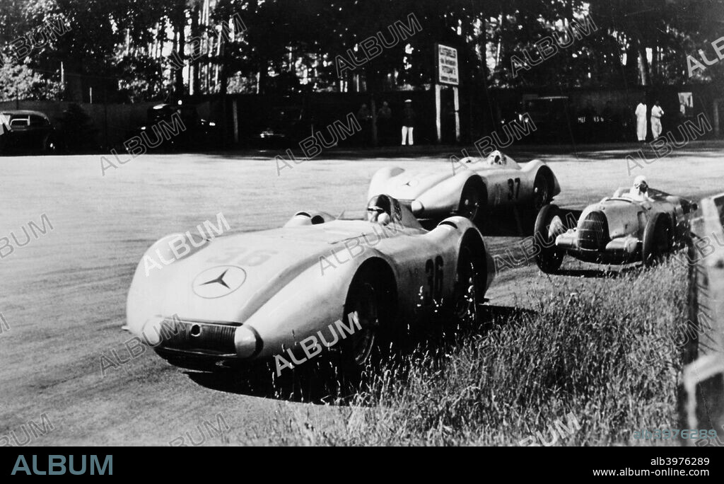 Mercedes Streamliner cars competing in the Avusrennen, Berlin, 1937. Both Mercedes and Auto-Union raced streamliner cars based on their speed record vehicles at Avus in 1937, registering lap speeds never since attained in a Formula race. Here the Mercedes of Manfred von Brauchitsch and Hermann Lang pass an Auto Union on the south curve. Lang (no 37) emerged as the winner of the race, watched by a crowd numbering 400,000.