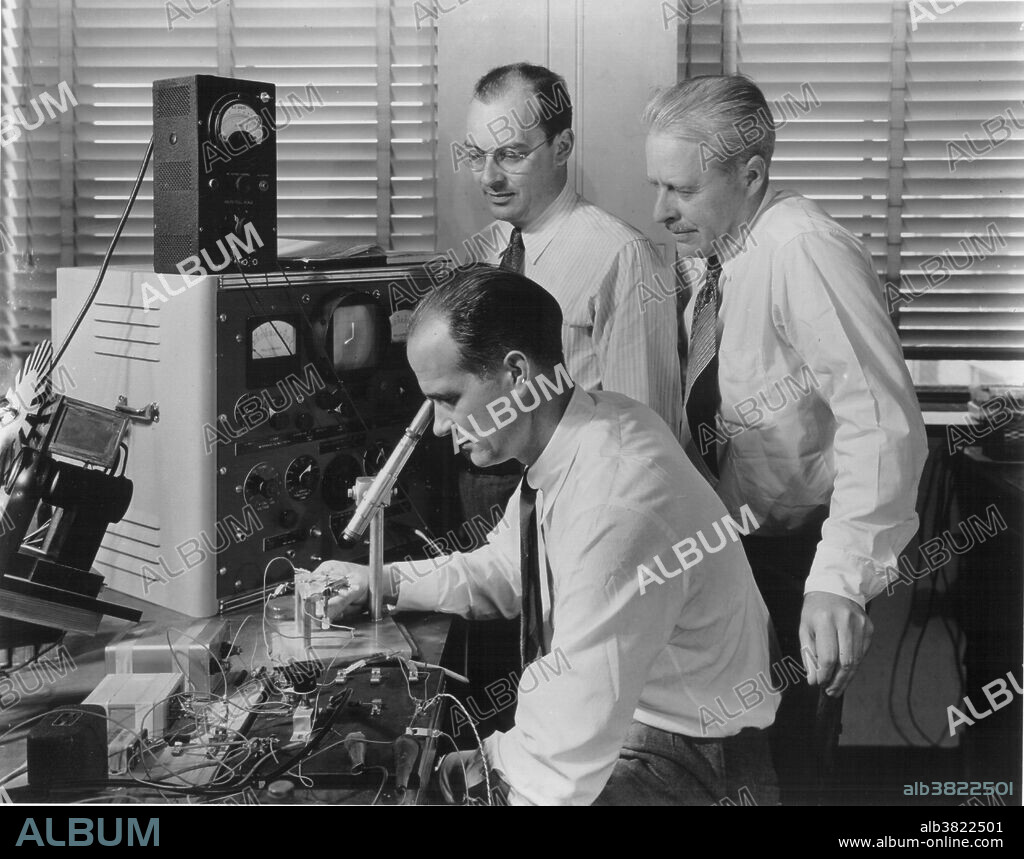 John Bardeen (1908-1991), William Shockley (1910-1989), and Walter Houser Brattain (1902-1987) (left to right) shown at Bell telephone laboratories in 1948 with an apparatus used in the early investigations which led to the invention of the transistor. These men won the Nobel Prize in Physics in 1956 for the invention of the transistor.