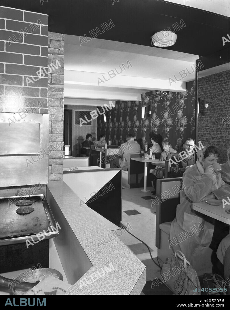 New Wimpy Bar, Barnsley, South Yorkshire, 1960. The interior of the new Wimpy Bar in central Barnsley which offered American style fast food. It opened in April 1960. Some of the strangely titled 'Pure Beef Hamburgers' can be seen cooking on the grill whilst customer wait for their 'fast' food.