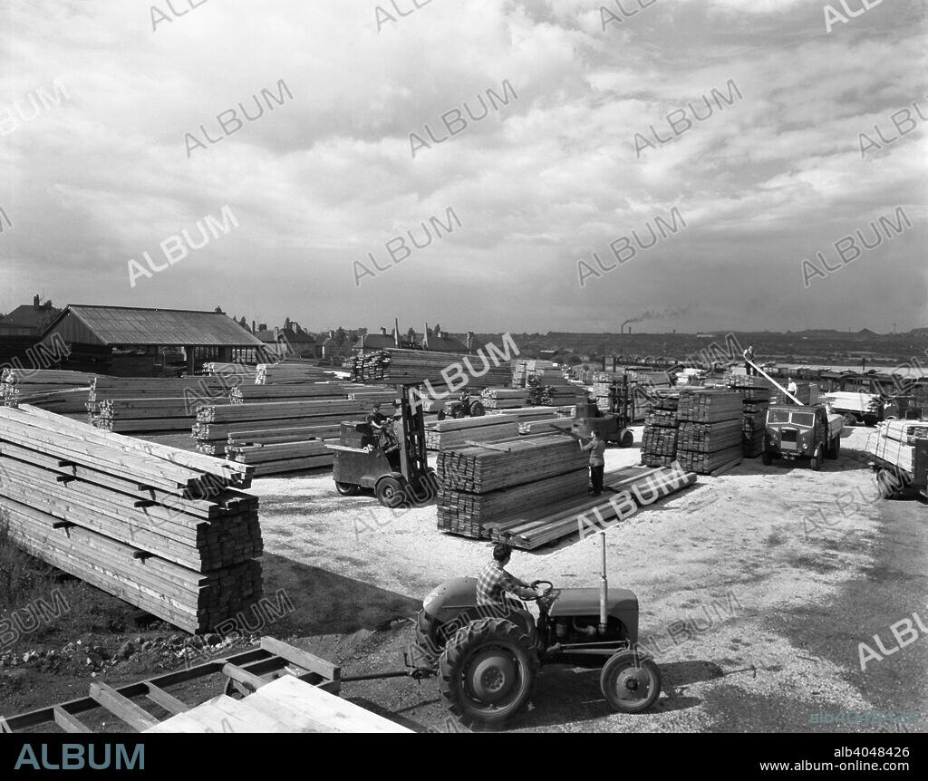 A busy timber yard, Bolton upon Dearne, South Yorkshire, 1960. The Goldthorpe Timber Company operated for many years from the nearby South Yorkshire village of Bolton upon Dearne. In this photograph, a substansial stock of timber can be seen with lorries being loaded. A similar scene would not be uncommon nearly fifty years later.
