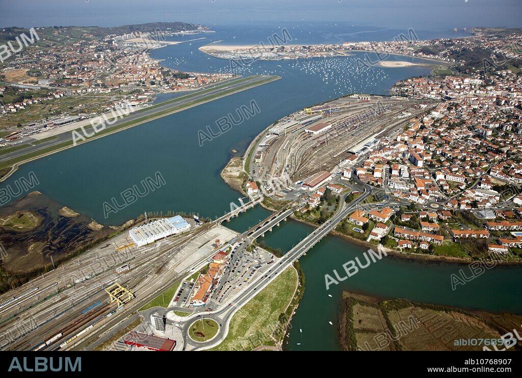 Puente de Santiago (bridge) and train stations, Irun (in foreground), Hendaye (centre, right), San Sebastian airport and Hondarribia (top left). Bidasoa river mouth, Txingudi bay, Spanish-French border.