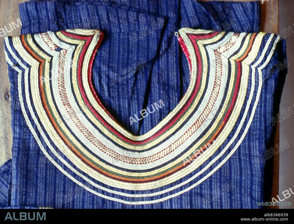 The <i>dhivehi libaas</i> is a traditional Maldivian dress for women. The neckline is adorned with what is called <i>kasabu viyun</i>, a collar hand stitched with silver and gold laces.<br/><br/>. Asia's smallest and least-known nation, the Republic of Maldives, lies scattered from north to south across a 750-kilometre sweep of the Indian Ocean 500 kilometres south-west of Sri Lanka. More than 1000 islands, together with innumerable banks and reefs, are grouped in a chain of nineteen atolls which extends from a point due west of Colombo to just south of the equator.<br/><br/>. The atolls, formed of great rings of coral based on the submarine Laccadive-Chagos ridge, vary greatly in size. Some are only a few kilometres square, but in the far south the great atoll of Suvadiva is sixty-five kilometres across, and has a central lagoon of more than 2000 square kilometres. The northern and central atolls are separated from each other by comparatively narrow channels of deep water, but in the south Suvadiva is cut off by the eighty-kilometre-wide One-and-a-half-Degree Channel. Addu Atoll is still more isolated, being separated from the atoll of Suvadiva by the seventy-kilometre-wide Equatorial Channel.