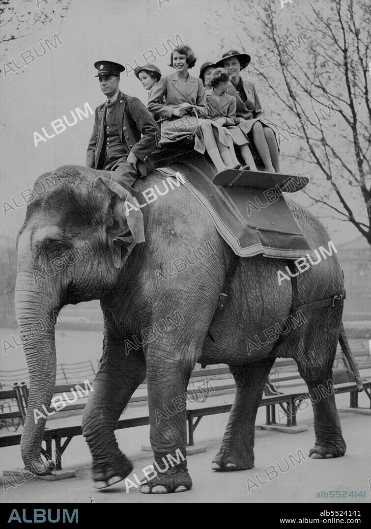 Princesses Take An Elephant Ride At The London Zoo -- Princess Elizabeth and Princess Margaret riding on an elephant at the London Zoo.
Princess Elizabeth and Princess Margaret temporarily forgot the parting from their parents - now on the way to Canada - when they paid an early morning visit to the London Zoo with a party of young friends.
They rode on the elephants, gave them tit-bits, took ***** in a llama carriage and spent a considerable watching the amusing baby Giant Panda. May 10, 1939.