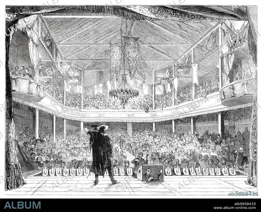 Interior of the Soldiers' Theatre at Mourmelon-le-Grand, Chalons Camp, [France] - from a drawing by M. Beaucé, 1860. 'This theatre, built of wood, and in the most unpretending style, at the cost of upwards of £2000, was opened as a private speculation in 1857...The granting or the withholding the permission to go to the theatre was found to exercise such a powerful influence on the conduct of the troops that at length the Emperor...determined upon converting it entirely into a theatre for the camp...The salle accommodates a thousand privates, three hundred sub-officers, and two hundred officers, who are all admitted gratuitously...A simple chandelier, furnished with oil-lamps, lights the salle, the upper parts of which are tastefully decorated with numerous flags...There is a performance every night in the week except Sunday. The piece performed on the night we "assisted" (and we were the only civilian present) was "Don Caesar de Bazan......The trooper looks forward to his periodical visit to the Theatre Imperial du Tivoli with unalloyed pleasure, and regulates his conduct in such a manner as to make his permission sure'. From "Illustrated London News", 1860.