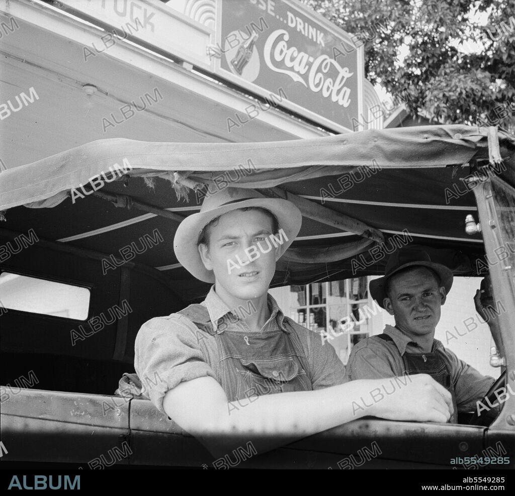 DOROTHEA LANGE. Young North Carolinian in old Ford. He does not farm. "Works for wages." At Tuck's filling station. Person County, North Carolina.