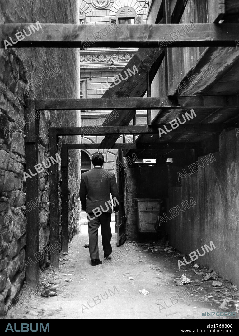 The Italian Communist Party headquarters in Trieste. A man walking past one of the back doors to the Italian Communist Party headquarters in Trieste. Trieste, 1970's.