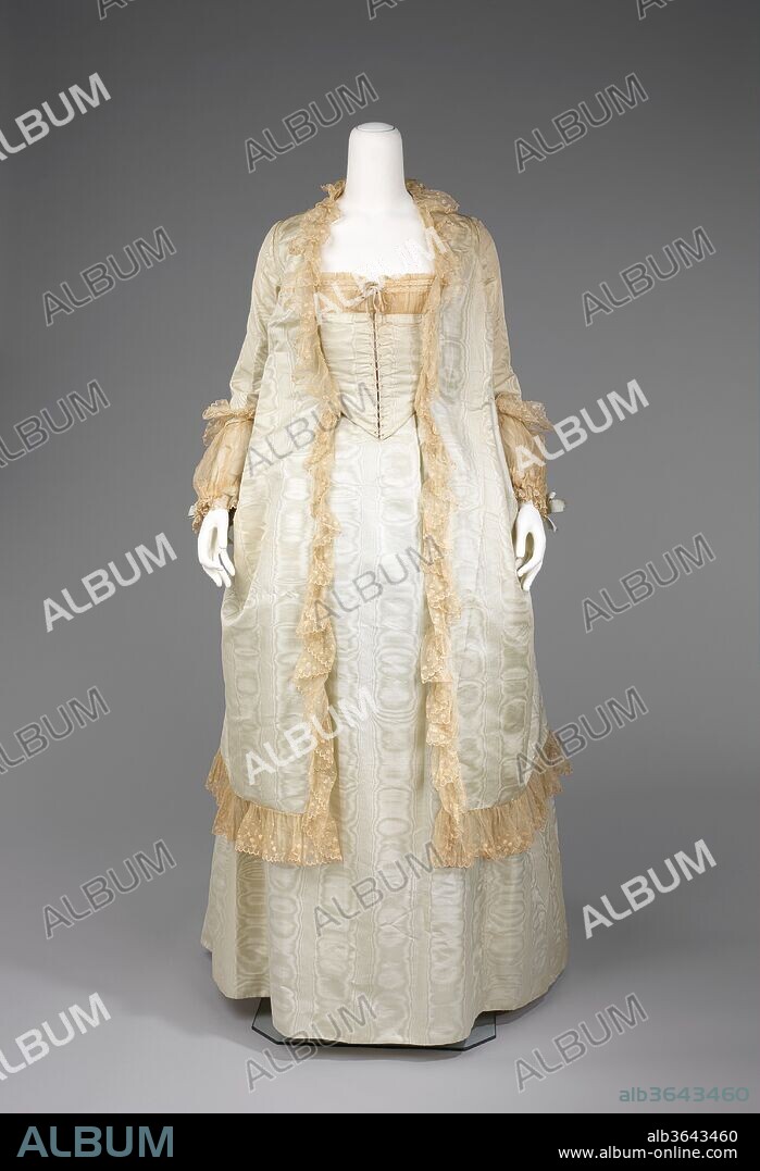 Tea gown. Culture: probably American. Date: 1875-80.
The teagown was intended to be worn at home while greeting receiving people.  As with most other 19th century garments it did not require the wearer to don a corset underneath.  This level of comfort was only permissible in one's own home.  An interesting construction aspect of this teagown is the back, which resembles a redingote and adds a masculine touch to a highly feminine garment.
The bustle silhouette, although primarily associated with the second half of the 19th century, originated in earlier fashions as a simple bump at the back of the dress, such as with late 17th-early 18th century mantuas and late 18th- early 19th century Empire dresses.  The full-blown bustle silhouette had its first Victorian appearance in the late 1860s, which started as fullness in skirts moving to the back of the dress.  This fullness was drawn up in ties for walking that created a fashionable puff.  This trendsetting puff expanded and was then built up with supports from a variety of different things such as horsehair, metal hoops and down.  Styles of this period were often taken from historical inspiration and covered in various types of trim and lace.  Accessories were petite and allowed for the focus on the large elaborate gowns.  Around 1874, the style altered and the skirts began to hug the thighs in the front while the bustle at the back was reduced to a natural flow from the waist to the train.  This period was marked by darker colors, asymmetrical drapery, oversize accessories and elongated forms created by full-length coats.  Near the beginning of the 1880s the trends altered once again to include the bustle, this time it would reach its maximum potential with some skirts having the appearance of a full shelf at the back.  The dense textiles preferred were covered in trimming, beadwork, puffs and bows to visually elevate them further.  The feminine silhouette continued like this through 1889 before the skirts began to reduce and make way for the S-curve silhouette.