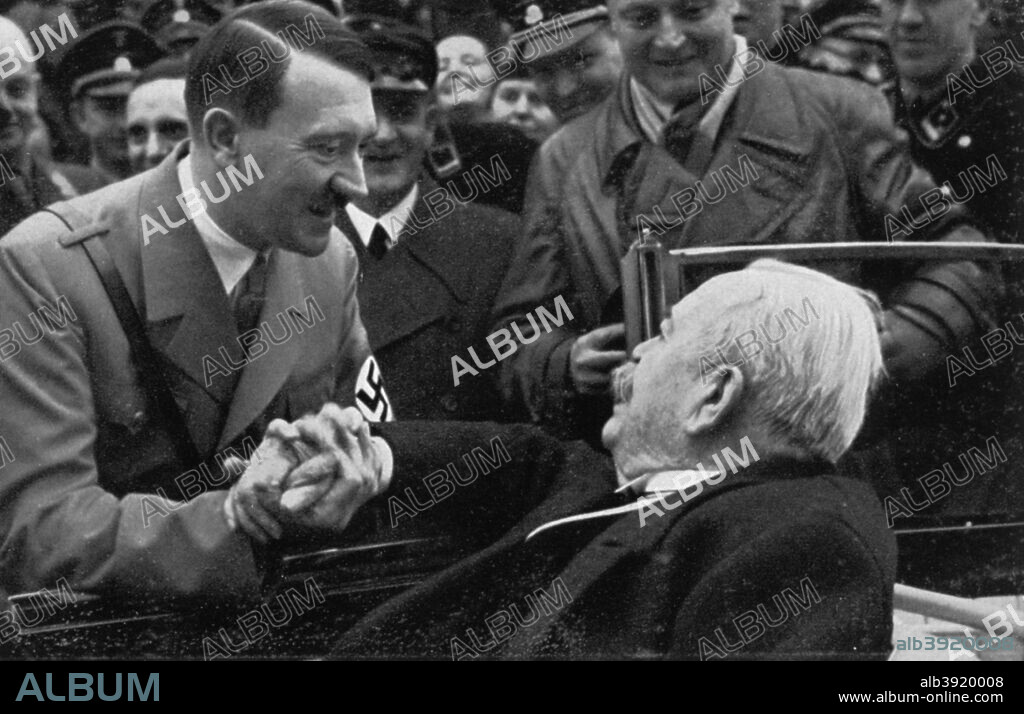 Adolf Hitler greeting General Karl Litzmann on his birthday, 1934. Hitler (1889-1945) congratulating Litzmann (1850-1936) on his 84th birthday. Litzmann was an infantry general in the First World War and went on to become a Nazi official. A print from Adolf Hitler. Bilder aus dem Leben des Führers, Hamburg: Cigaretten/Bilderdienst Hamburg/Bahrenfeld, 1936.