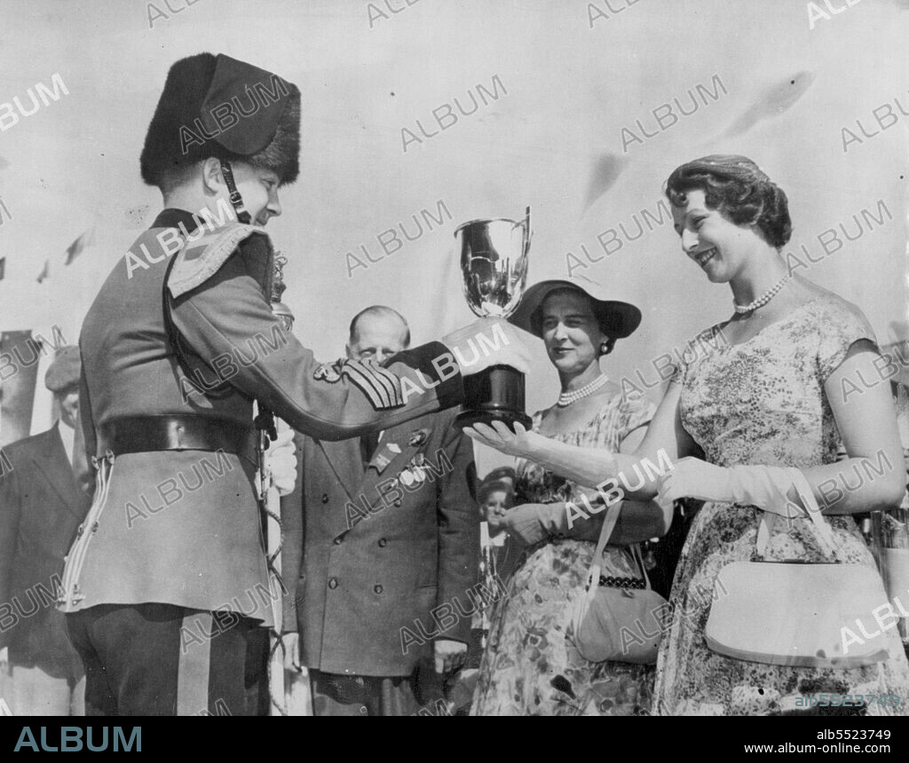 Princess Makes Presentation -- Princess Alexandra, watched by her mother, the Duchess of Kent, presents the cup to Trumpet Major A. F. Smith, of the Second Signals Regiment trumpet band, during Warriors Day ceremonies at the Canadian National Exhibition, opened by the Royal visitors during their visit to Toronto on their Canadian tour. September 04, 1954. (Photo by Reuterphoto).