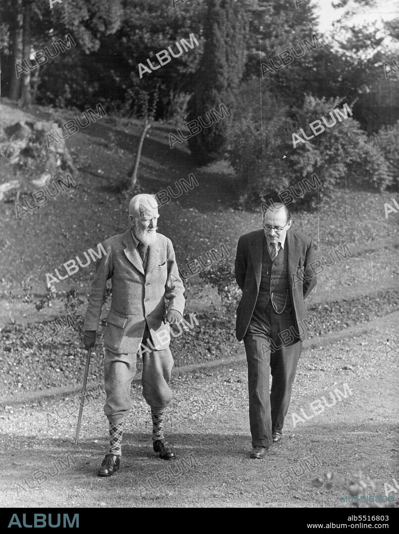 Shaw's Boswell - Walking together in the garden of "Shaw's Corner" at Ayot St Lawrence in Hertfordshire. Once Shaw took many walks in the leafy lanes around his home; now takes his exercise in the garden. He has lived at Ayot for forty years; and it was there that Loewonttain first met him, ten years ago. Now Loewenstein lives in Wheathampstead, nearby, works at the house seven hours a day, five days a week, and spends the week-end at home in London. July 28, 1947. (Photo by Pictorial Press).