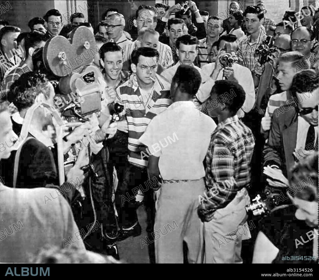 Little Rock, Arkansas: September 9, 1957. Students at the North Little Rock HIgh School  blocked the doors of the school to prevent six Negro students who had been enrolled earlier at the school from entering. The picture shows a white student daring a Negro to try and enter. Just after this picture was taken, the Negroes were shoved down a flight of stairs and out to the sidewalk.