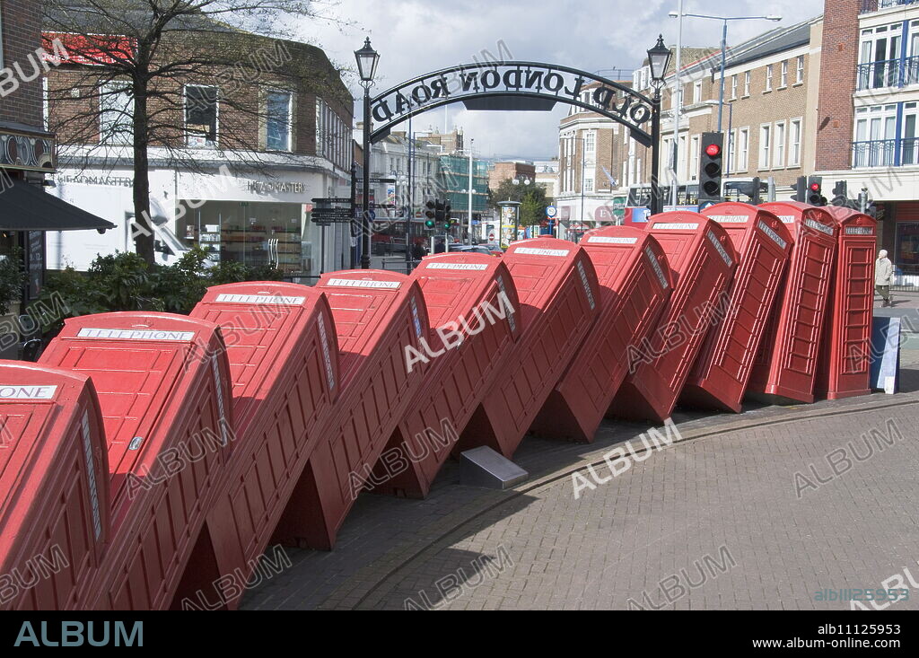 Red telephone box sculpture Out of Order by David Mach. Kingston Upon Thames, Surrey, England, United Kingdom, Europe.