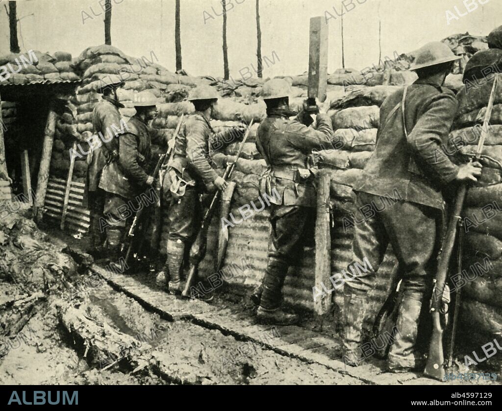 Allied soldiers using periscopes, Flanders, First World War, 1915-1916, (c1920). 'Ready to Repel an Attack: Canadian Infantry in the trenches wearing the new steel helmets'. From "The Great World War: A History", Volume V, edited by Frank A Mumby. [The Gresham Publishing Company Ltd, London, c1920].