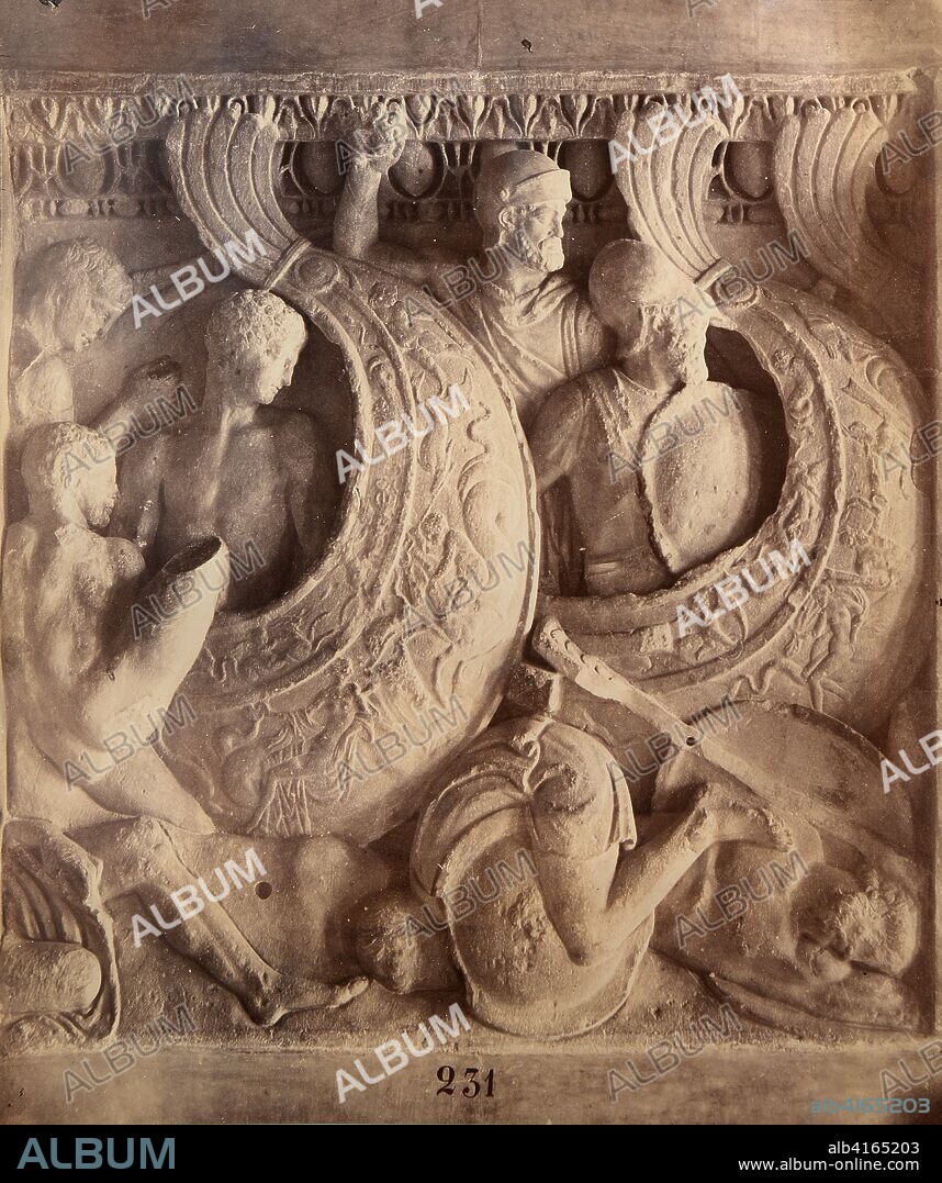 Detalle de un friso clásico con bajorrelieves de guerreros y escudos en batalla (231).
