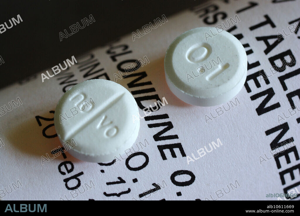 Two Clonidine (0.1 mg) pills. Clonidine is a drug used to treat several medical conditions, most common being high blood pressure. It is also used to treat some types of neuropathic pain, opioid detoxification, sleep hyperhidrosis, and as veterinary anaesthetic drug. It may also be used in the treatment of Tourette syndrome. Chemical name: N-(2,6-dichlorophenyl)-4,5-dihydro-1H-imidazol-2-amine. Formula C9 H9 Cl2 N3, Mol. mass 230.093 g/mol. Each pills is 8 mm in diameter. Image width: 28.65 mm. Magnification: 3.49x if the image is printed 10 cm wide.