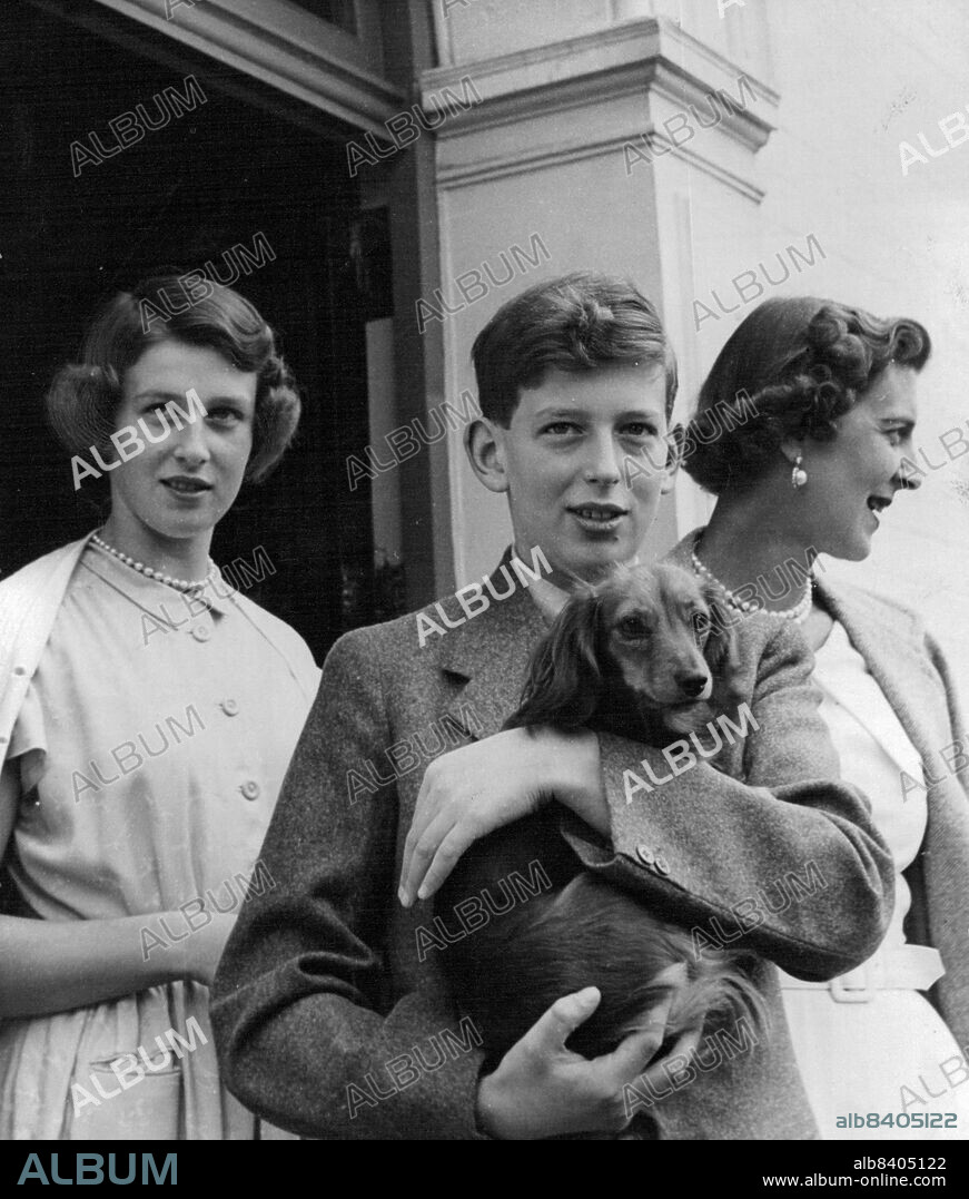 H.R.H. The Duchess of Kent At Her Country Residence -- Photographed at Coppins, Iver, Buckinghamshire are their Royal Highnesses the Duchess of Kent with her two eldest children, Princess Alexandra and Prince Edward, Duke of Kent who is holding Mumphie the family pet dachshund. February 27, 1953. (Photo by Tom L. Blau, Camera Press).