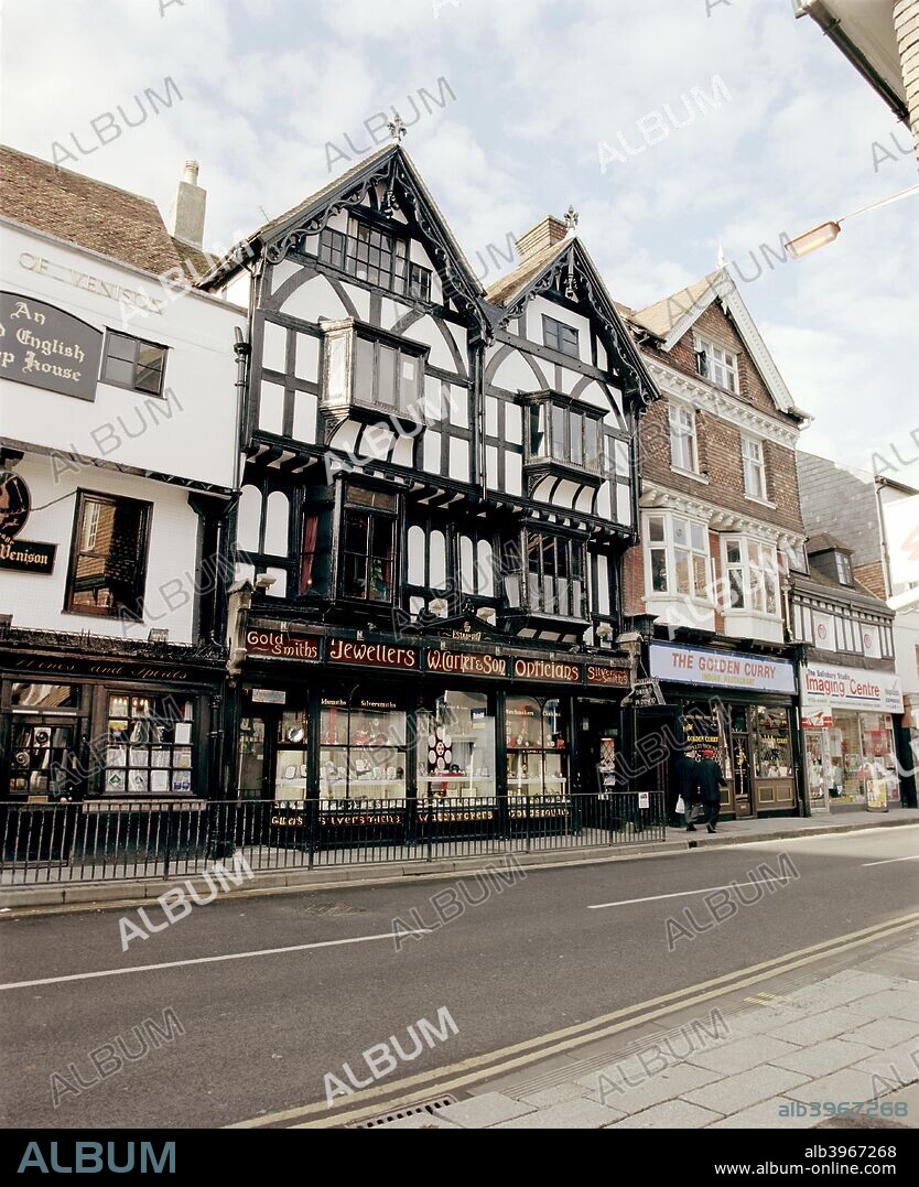 W Carter & Son, Minster Street, Salisbury, Wiltshire, 2000. This Jeweller and Optician, is comprised of two four storey half timbered properties and is probably Tudor in date. It sits in the centre of a run of buildings of similar date, one of which is tile-hung. In several cases the shop frontages have drastically altered the character of the buildings.