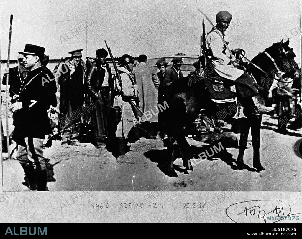 SOLDADOS REPUBLICANOS PASANDO LA FRONTERA FRANCESA EN 1939, VIGILADOS POR GENDARMES Y TROPAS MORAS.