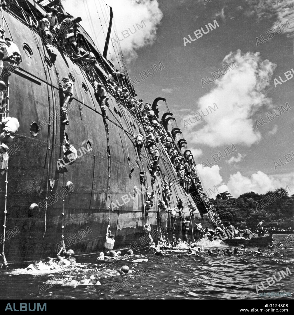 Espiritu Santo, Vanuatu:   October 26, 1942. The troop carrier, USS President Coolidge goes down in the harbor at Espiritu Santo in the South Pacific after hittng a friendly mine. She had previously been a luxury liner of the Dollar Steamship Line, and was converted for the war. The captain had not been told of the mines in the harbor. There were two casualties out of the 5340 men aboard.
