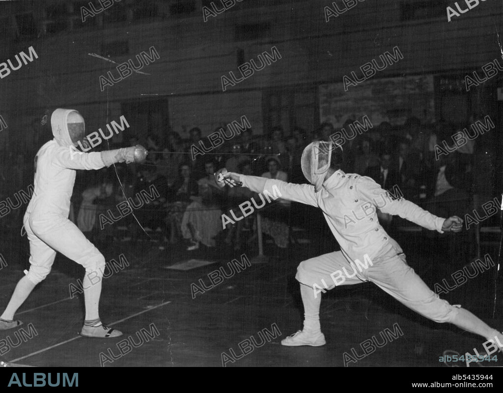 British Empire Games 1950. Empire Games Fencing at Auckland Feb 8th. C.L. de Beaumont, left , capital of the English team, and R.R. Paul, England, Winner of the individual foil title, in an Exhibition match after the championships. One of Sydney's oldest fencing clubs, the foils club, will soon sheath its swords unless new rooms are found. February 14, 1950.