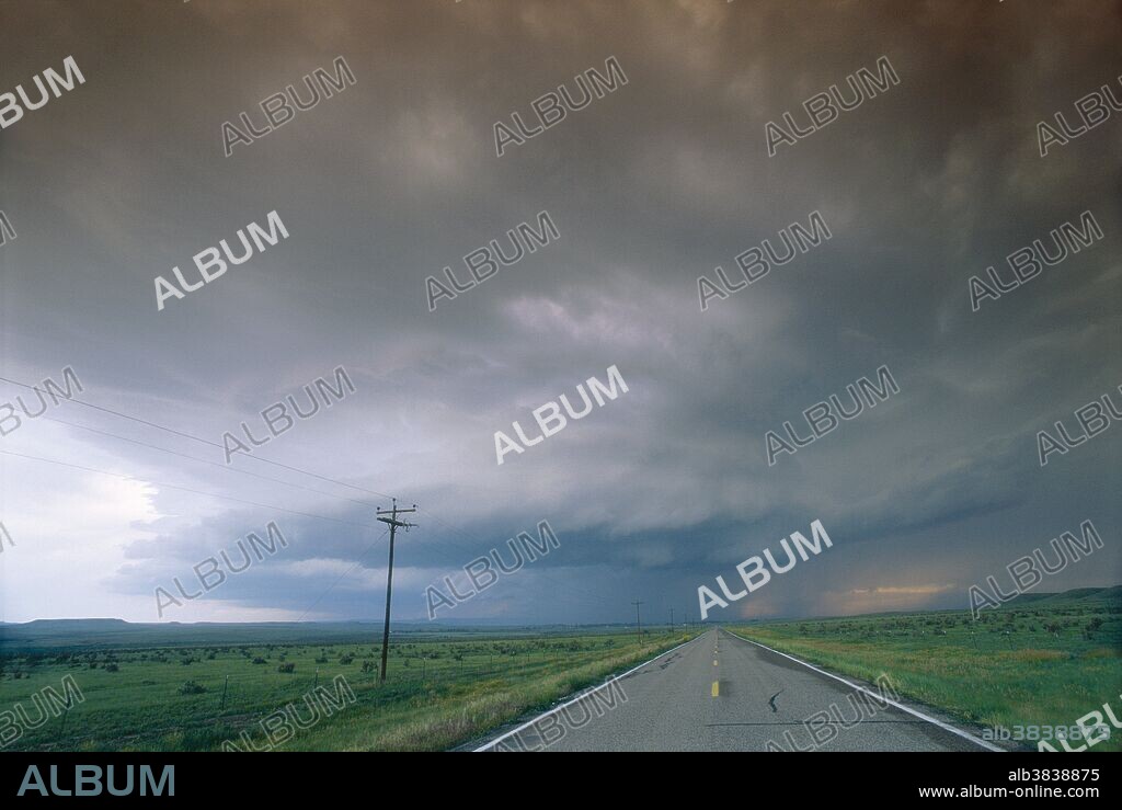 Mesocyclone thunderstorm. Tornados develop from these intense thunderstorms that begin to spin because high-level winds are blowing faster and in a different direction to low-level winds. The rotation can be enhanced by the interaction of cold and warm air currents, causing a mesocyclone, which is a powerful air column moving upward at the centre of the storm. From this stage, the spin might intensify and a rotating column of air will break through the wall cloud and hit the ground, forming a tornado. Photographed in Colorado, USA.