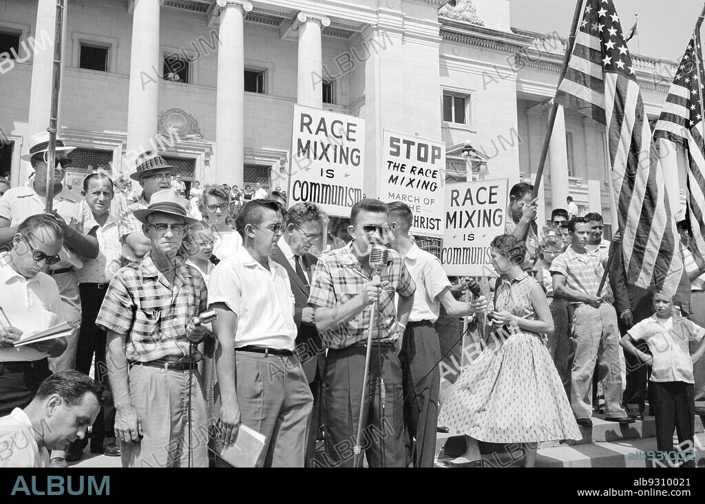 Crowd at Arkansas State Capitol protesting integration of Central High School, with signs reading ""Race mixing is Communism"" and ""Stop the race mixing,"" Little Rock, Arkansas, USA, John T. Bledsoe, U.S. News & World Report Magazine Photograph Collection, August 20, 1959.