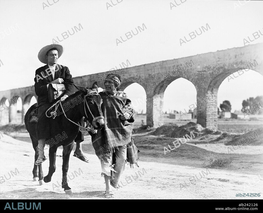 HENRY FONDA and J. CARROL NAISH in THE FUGITIVE, 1947, directed by JOHN FORD. Copyright RKO.