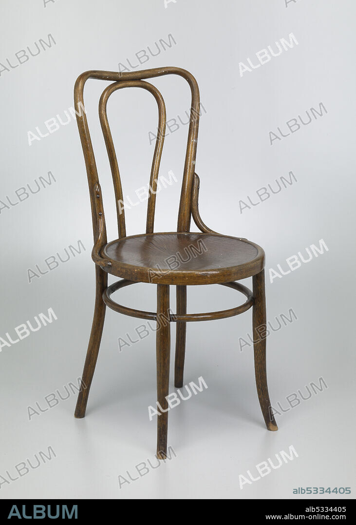 JACOB AND JOSEF KOHN. Four-legged wooden, bentwood chair. Chair seat is round with carved, shallow ridges on seat top. Ridges are in expanding, concentric "U" shapes, narrower in the middle and expanding outward toward the center. "U" shapes begin on either side, closer to the chair back. Outside wood bar, one continuous piece, of chair back curves around and down to make the chair legs. In the middle of the chair back is another curved loop of bent wood that attaches to the top bar and to the seat. Two (2) curved supports on either side of the chair seat connect to the chair back. Circular wood ring of support runs around the interior of the four (4) legs. Two (2) front legs slightly curve away from the seat.