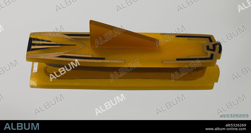 It is made of semi-translucent orange Bakelite plastic and is rectangular in shape with an oval bowl that is missing a large section. On the bottom side of the case there is a green sticker with black type that reads "Horne". Lena Horne (1917-2010) was an African-American dancer, actress, singer and civil rights activist.