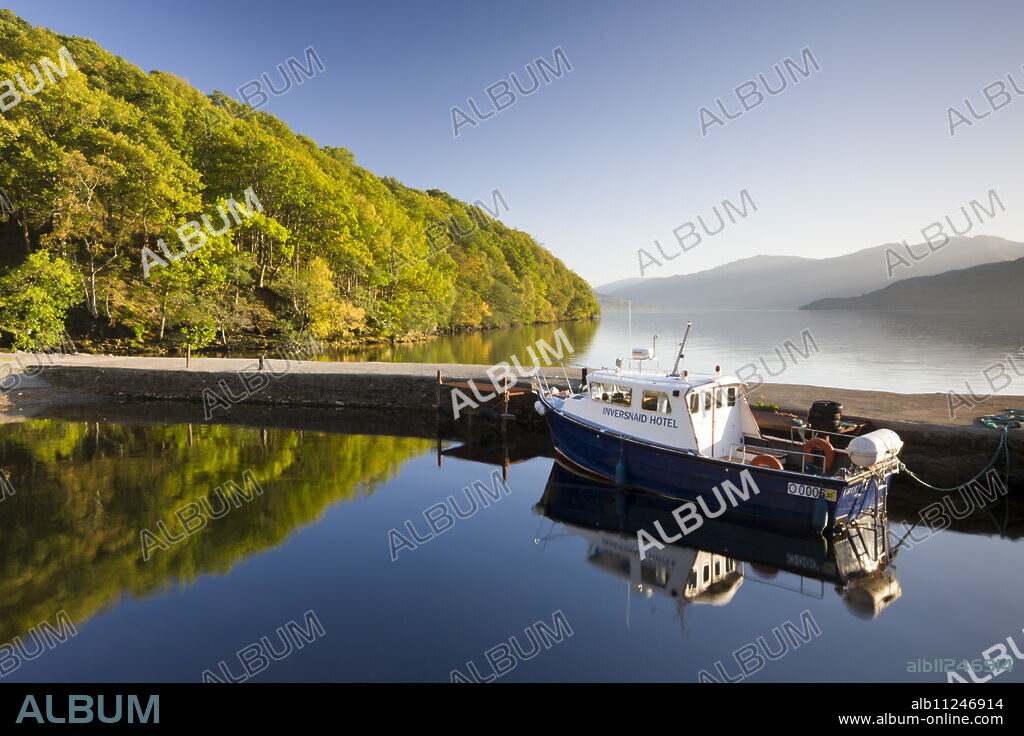Boat moored in the small Inversnaid Hotel harbour on Loch Lomond, Loch Lomond and The Trossachs National Park, Stirling, Scotland, United Kingdom, Europe.