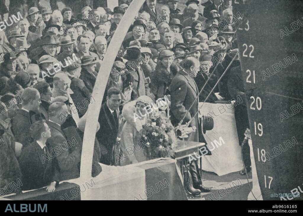 'A Happy Ceremony. H.R.H. the Duchess of York, accompanied by the Duke of York, about to launch the P. & O. liner Strathmore on April 4, 1935', 1936. From Shipping Wonders of the World, Vol. 1, edited by Clarence Winchester. [The Amalgamated Press Ltd., London].