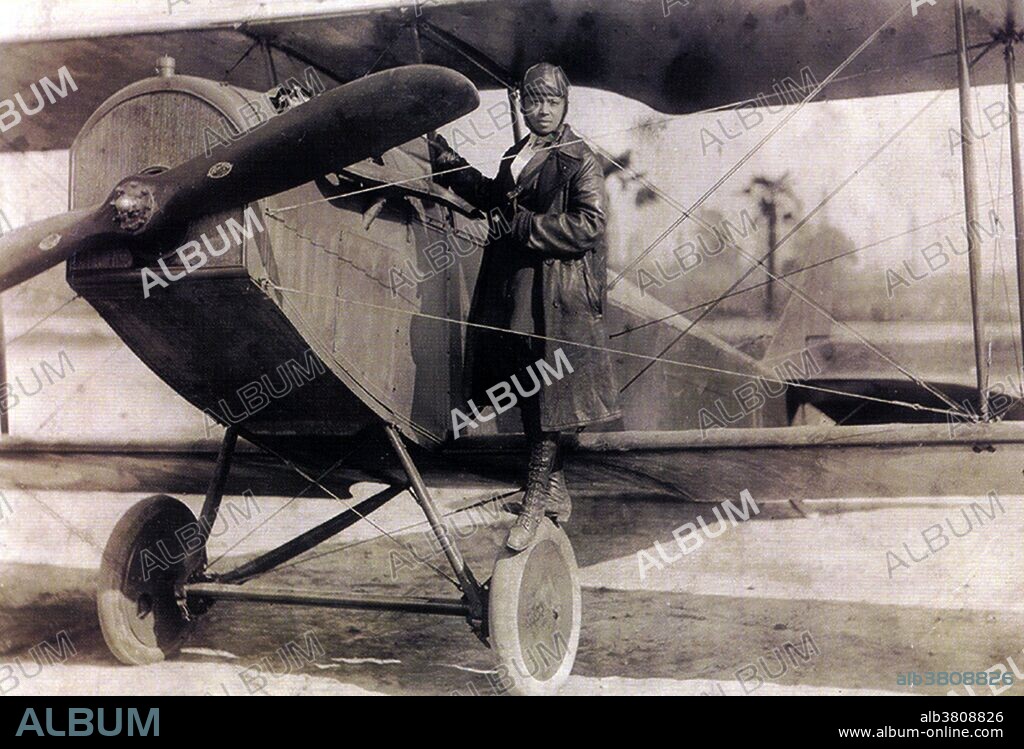Elizabeth "Bessie" Coleman (January 26, 1892 - April 30, 1926) was an African-American civil aviator. She could not gain admission to American flight schools because she was black and a woman. Robert Abbott, founder and publisher of the Chicago Defender, encouraged her to study abroad. She took a French-language class at the Berlitz school, and traveled to Paris in 1920, to earn her pilot license. In 1921, she became the first woman of African-American descent to earn an international aviation license (the first American of any gender or ethnicity to do so). She became a barnstorming stunt flyer and was known as "Queen Bess". She quickly gained a reputation as a skilled and daring pilot who would stop at nothing to complete a difficult stunt. On April 30, 1926, William Wills, her mechanic and publicity agent, was flying the plane with Coleman in the other seat. She had not put on her seatbelt because she was planning a parachute jump for the next day and wanted to look over the cockpit sill to examine the terrain. Ten minutes into the flight, the plane unexpectedly dived, then spun around. She was thrown from the plane at 2,000 feet and died instantly when she hit the ground. She was 34 years old. No photographer credited, 1922.