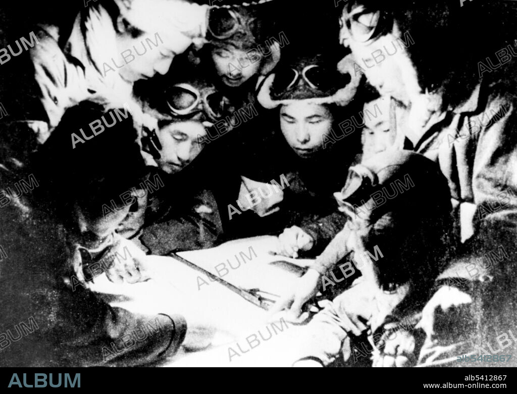 Japanese Kamikaze pilots are briefed the night before a sortie, 1944-45. Kamikaze were a part of the Japanese Special Attack Units of military aviators who initiated suicide attacks for the Empire of Japan against Allied naval vessels in the closing stages of the Pacific campaign of WWII, designed to destroy warships more effectively than possible with conventional air attacks. About 3,800 kamikaze pilots died during the war, and more than 7,000 naval personnel were killed by kamikaze attacks. Kamikaze aircraft were essentially pilot-guided explosive missiles. (cropped and cleaned).