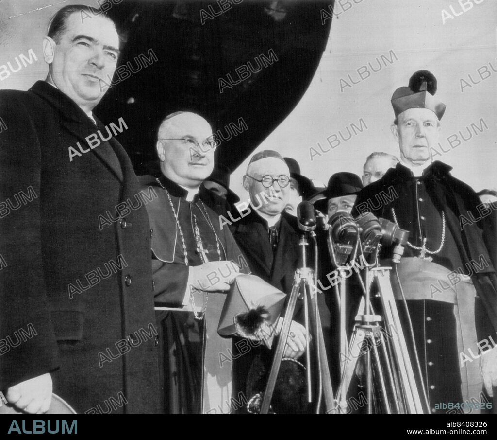Cardinals-Designate Leave For Rome -- As they were bid barewell by Mayor William O'Dwyer (left) at La Guardia airport here this afternoon just prior to departure for Rome by plane, left to right, were Archbishop Francis J. Spellman of New York, Bishop Thomas Tien of China and Archbishop John Joseph Glennon of St. Louis. They are standing beside their plane, "Star or Rome." February 11, 1946. (Photo by AP Wirephoto).