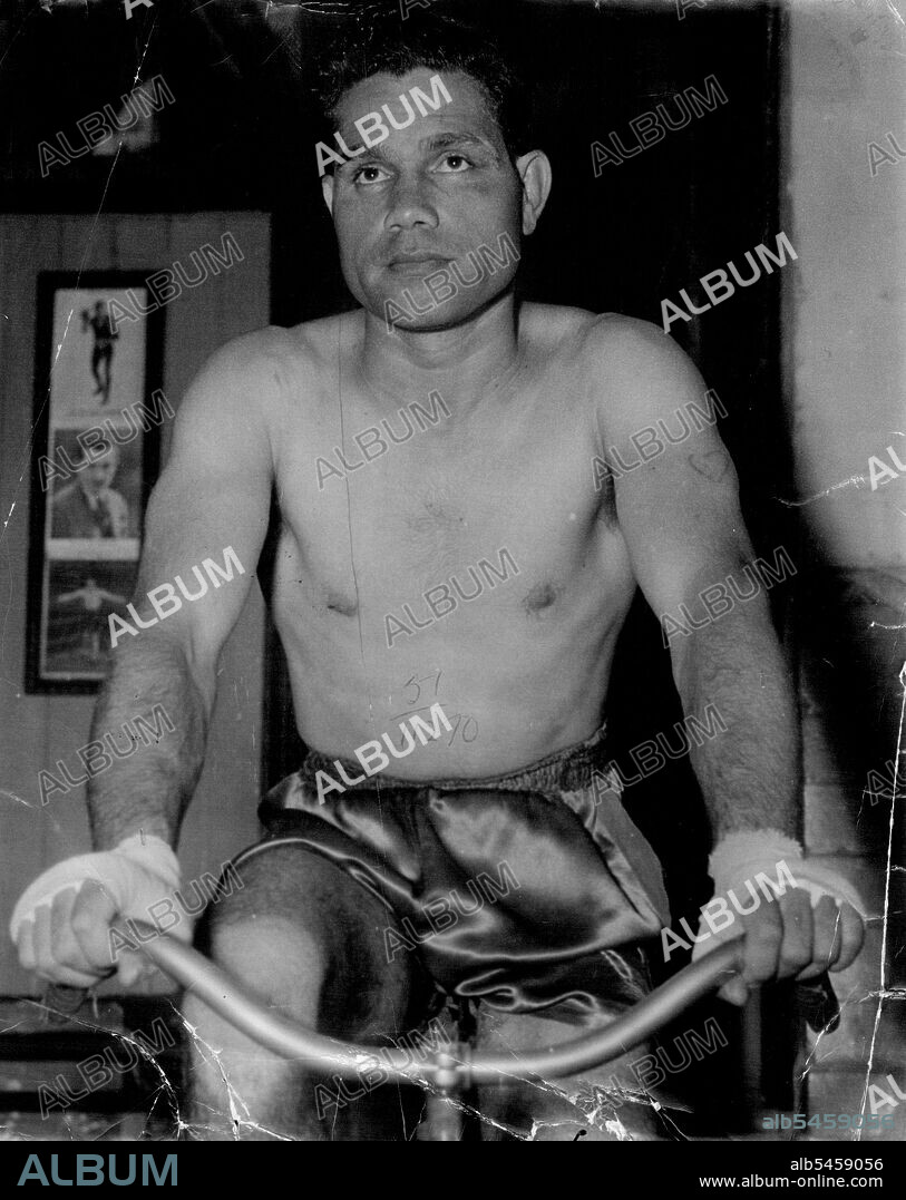 Australian lightweight champion Jack Hassen in training this week for his fight against welter champion Mick Tollis at the Stadium on Monday night.He was an expressionless boxer, not winning when a blow got through and not saying anything as he sat upright in his corner between rounds. March 17, 1951. (Photo by Sporting Life).