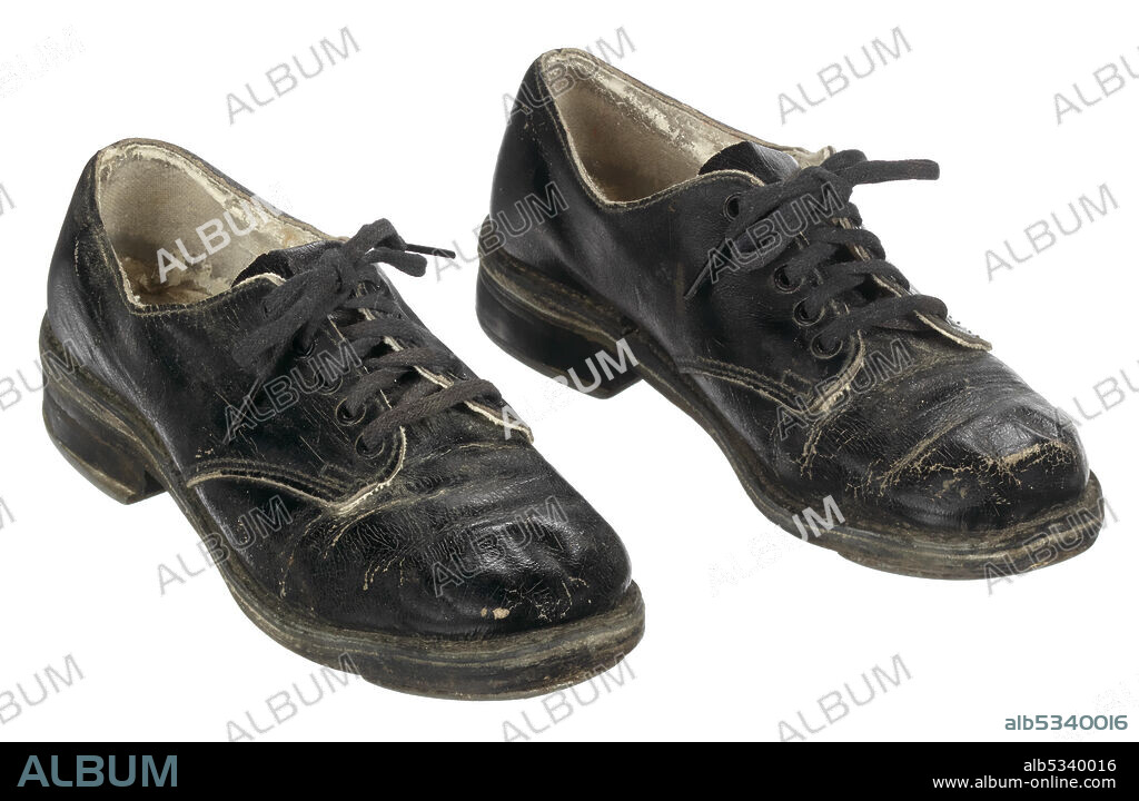 WINDSOR SHOE COMPANY. This pair of child's tap shoes were used by African-American singer, dancer, actor and comedian Sammy Davis Jr. (1925-1990) when he travelled the vaudeville circuit as part of the Will Mastin Trio. The shoes have black leather uppers and close across the center front over a split vamp with a tongue using black cotton shoelaces tipped with plastic or leather aglets. The leather outsoles are machine stitched to the midsole and the uppers as in a welted shoe. Rubber heels are adhered to the soles. Stamped onto the bottom of the heels is a "W" inside of a shield with the word "WINDSOR" below the shield. Metal toe taps are nailed to the outsole and metal heel taps are nailed to the rubber heel. The heel taps have an open area in the middle so that the manufacturer's mark can be seen on the rubber heel bottom.