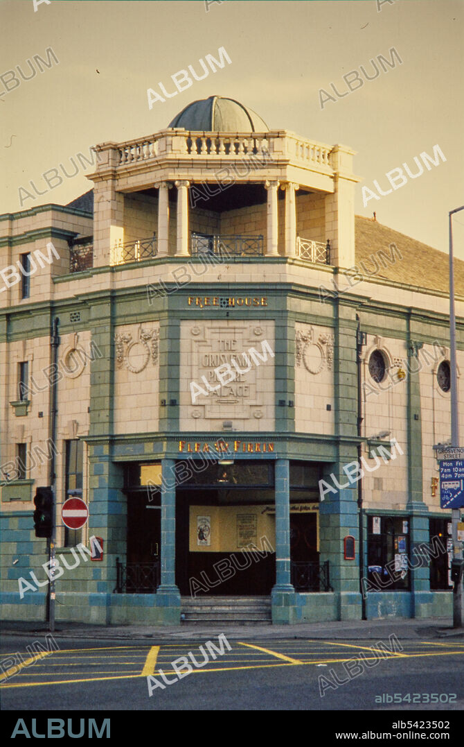 NORMAN WALLEY. Flea and Firkin Public House, Grosvenor Street, Manchester, 1990-1994. The corner entrance of the Flea and Firkin public house viewed from the north-west, showing the green tiling and plaque of raised lettering of the building's original name. The Grosvenor Picture Palace opened in 1915. From the 1960s it was used for bingo, first in addition to showing films and later as a sole function. It then became a snooker club. The building remained largely unaltered until it was converted into a pub which opened in 1990, though much of the interior remains intact.