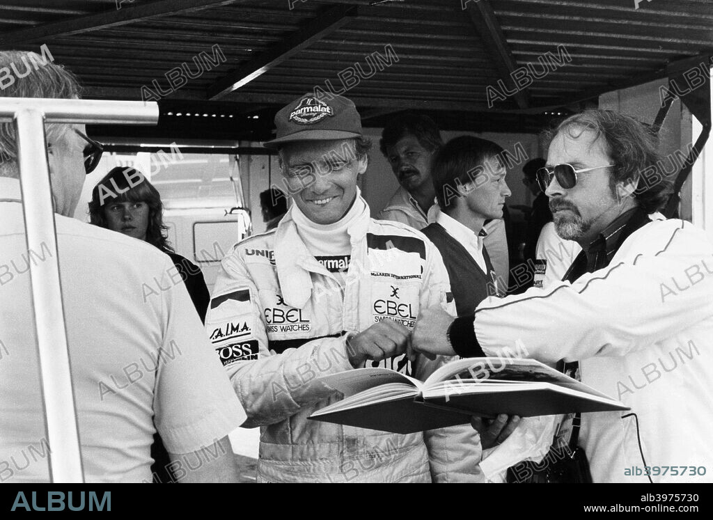 Niki Lauda, F1 driver for Marlboro McLaren, at the European Grand Prix, Brands Hatch, Kent, 1983. Lauda's first stint in Formula One lasted from 1971 to 1979, and  included two World Championships for Ferrari. In 1976 he was badly burned in a near fatal crash at the German Grand Prix at Nurgurgring. Just six weeks later, at Fuji Japan, he withdrew from the final Grand Prix of the season, despite being in the lead, due to the extreme wet weather conditions. He returned to racing in 1982 until 1985, winning a World Championship for McLaren in 1984, and becoming a mentor to Alain Prost.
