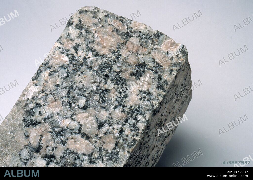 Sample of granite, showing its component minerals of quartz, feldspar, mica and hornblende. The pink crystals are feldspar. The quartz is gray, and the mica and hornblende are the dark spots.